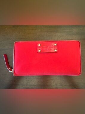 kate spade bright red zip-around wallet with logo plaque